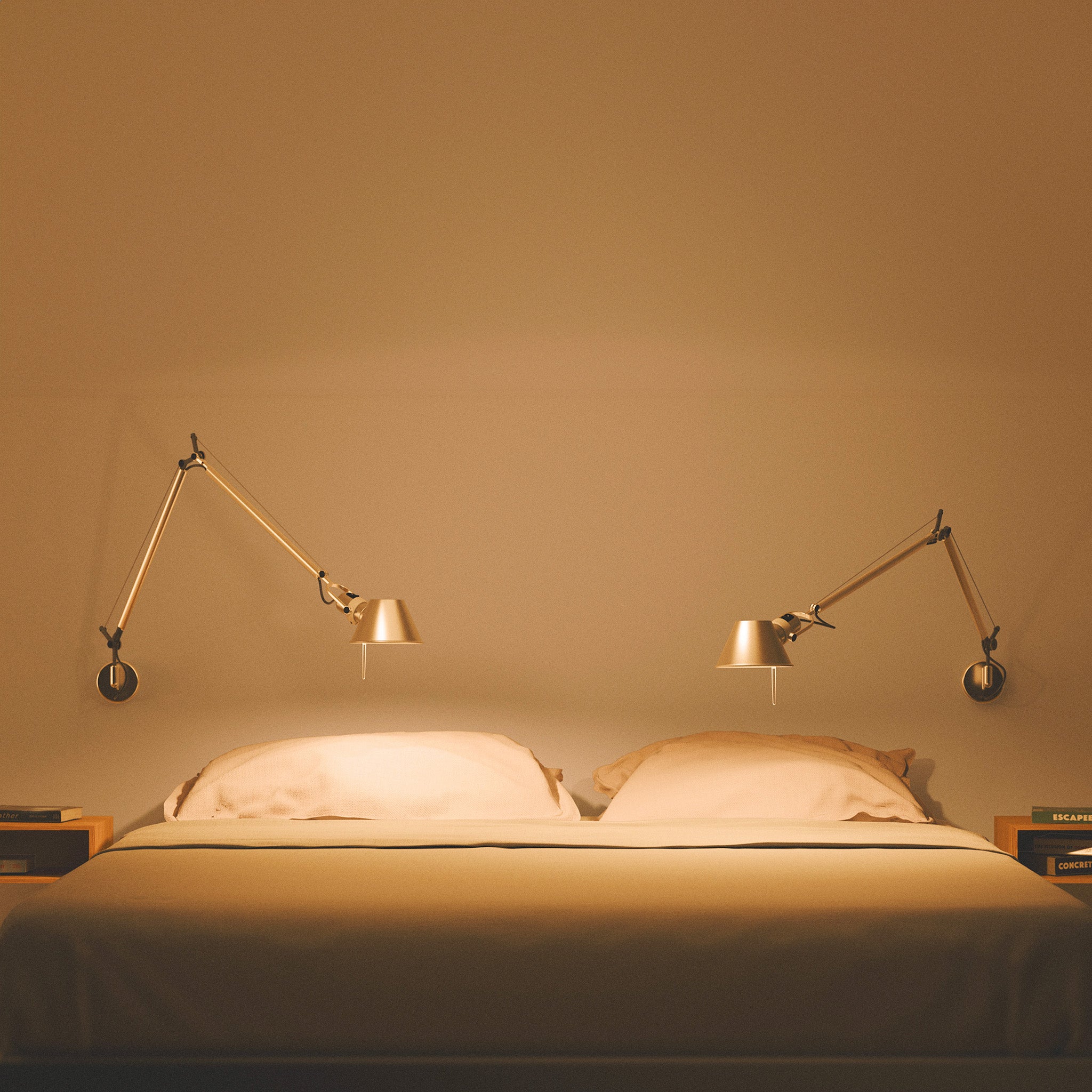 A cozy bedroom with two Tolomeo lamps pointing downwards, emitting warm 2700K light with 98+ CRI to create a relaxing evening atmosphere, perfect for unwinding.